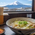 Bowls of Yoshida udon in a small Fujiyoshida restaurant with Mt. Fuji outside