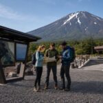 Travelers check route information near a clean Mt. Fuji 5th Station planning area