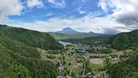 Aerial view of Saiko Iyashi-no-Sato Nenba village with Mt. Fuji in the distance