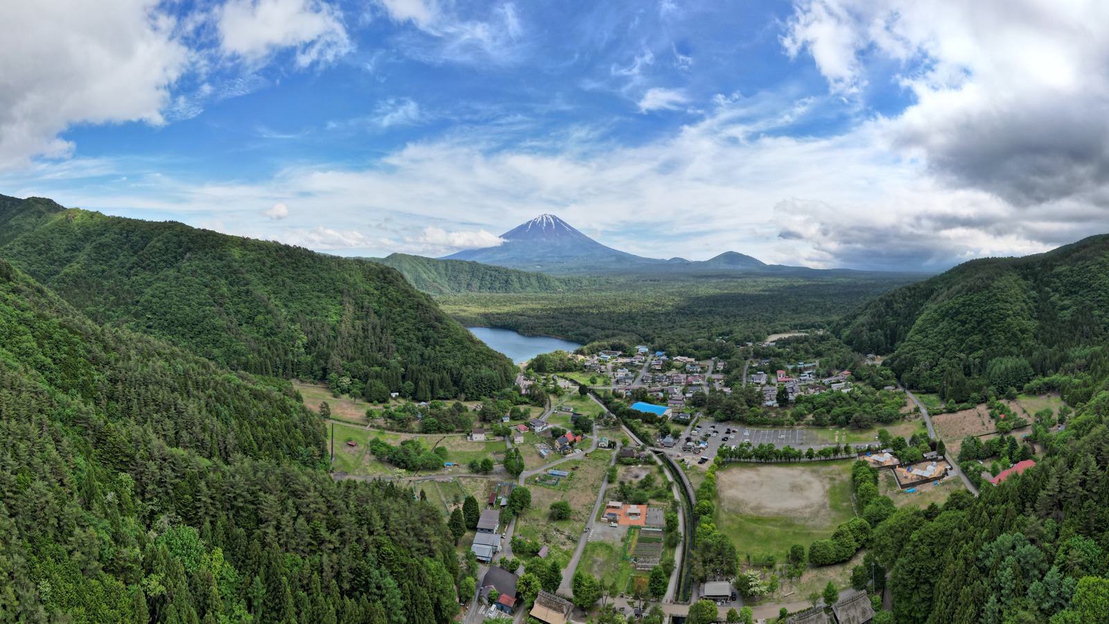 Aerial view of Saiko Iyashi-no-Sato Nenba village with Mt. Fuji in the distance