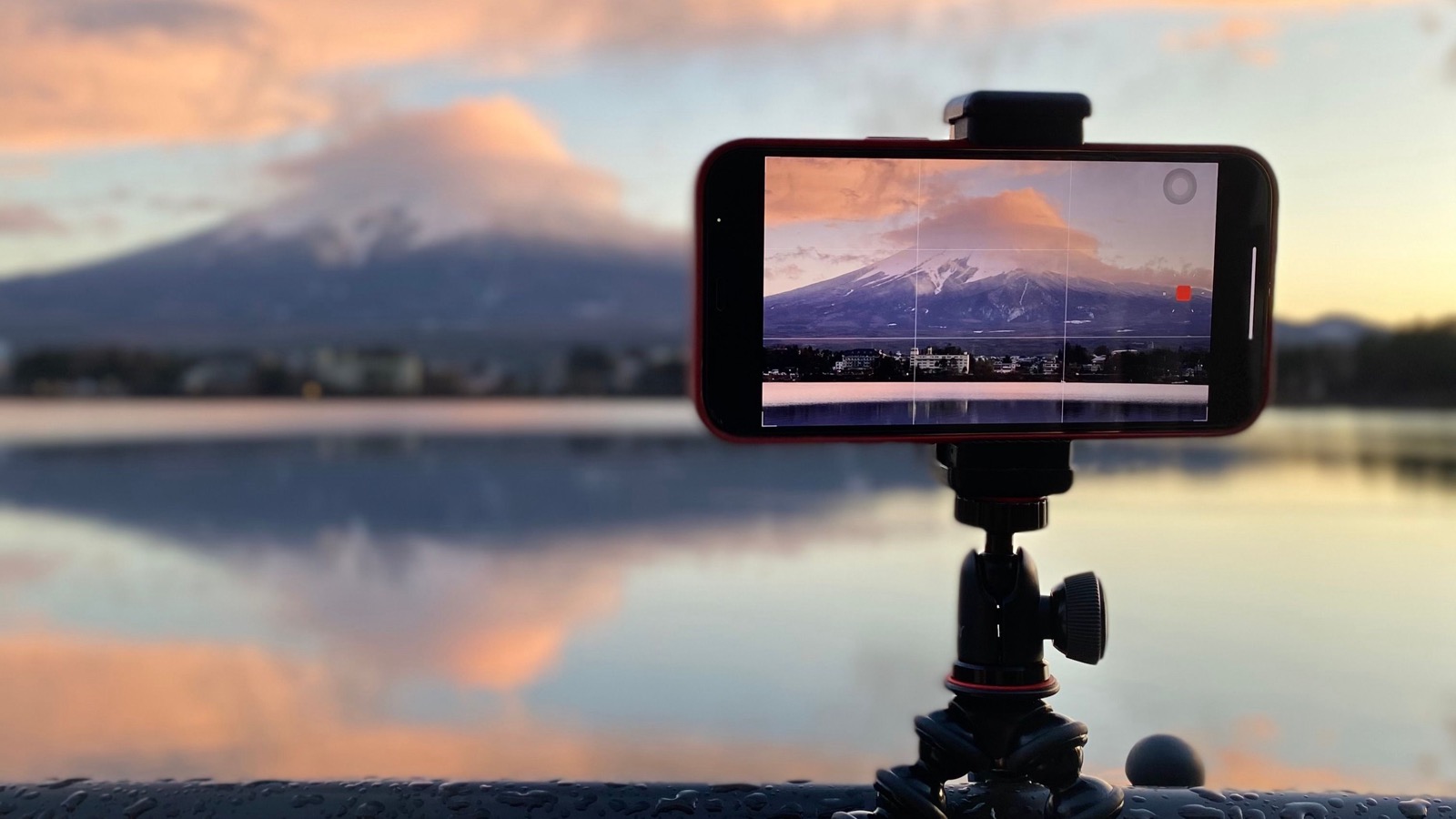 A smartphone recording Mount Fuji beside Lake Kawaguchiko