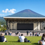 Outdoor event stage in an amusement park near snow-free Mount Fuji