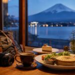 Cafe table near Lake Kawaguchiko with food and Mt. Fuji visible at blue hour