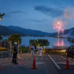 Lake Kawaguchiko fireworks behind a controlled lakeside parking entrance