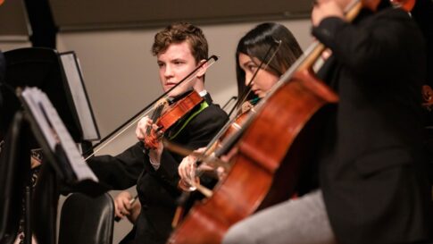 Young string musicians performing indoors for the Kawaguchiko Music Forest concert update