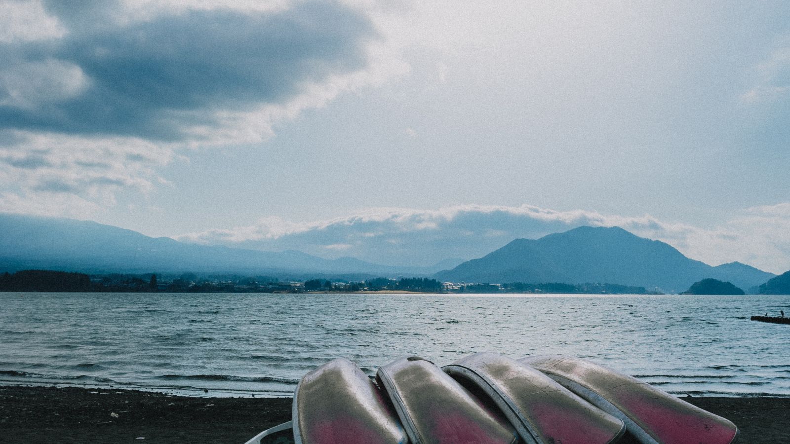 Travelers looking toward Mount Fuji from a lakeside path for Lake Kawaguchiko 2 Day Itinerary: 1-Day and 2-Day Travel Plan