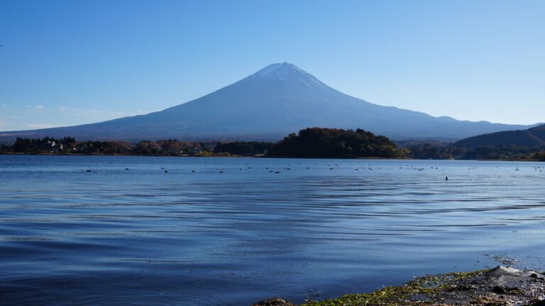 Hikers pausing while clouds move across a Mt. Fuji trail