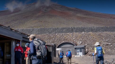 Hikers near a Mount Fuji support station for an emergency contacts update
