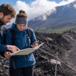 Travelers checking a map on a volcanic Mt. Fuji trail in summer weather