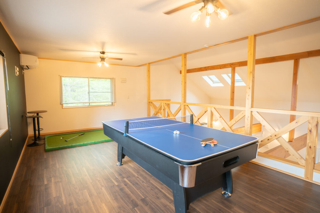 Playroom at Kinfolk Yamanakako with table tennis and a putting mat