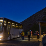 Overnight coach arriving at a snow-free Mount Fuji mountain terminal before dawn