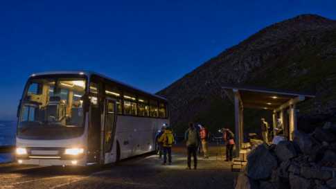 Overnight coach arriving at a snow-free Mount Fuji mountain terminal before dawn