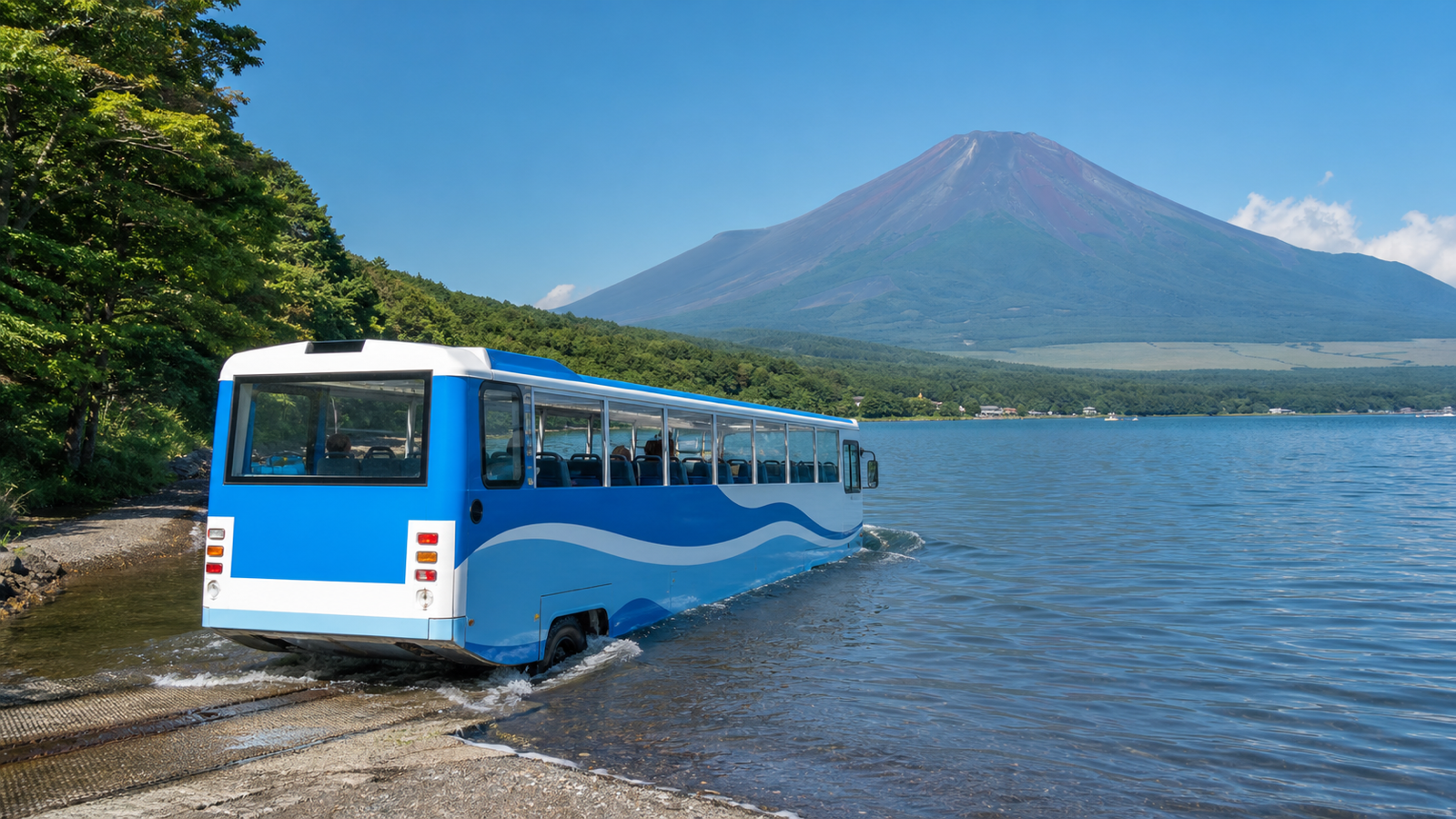 Unbranded amphibious sightseeing bus entering Lake Yamanaka below snow-free Mount Fuji