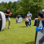 Text-free families playing a safe outdoor infrared tag game with colorful toy devices in a forest park