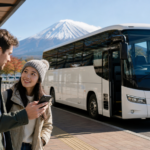 Travelers checking an online reservation beside an unbranded highway bus near Mount Fuji
