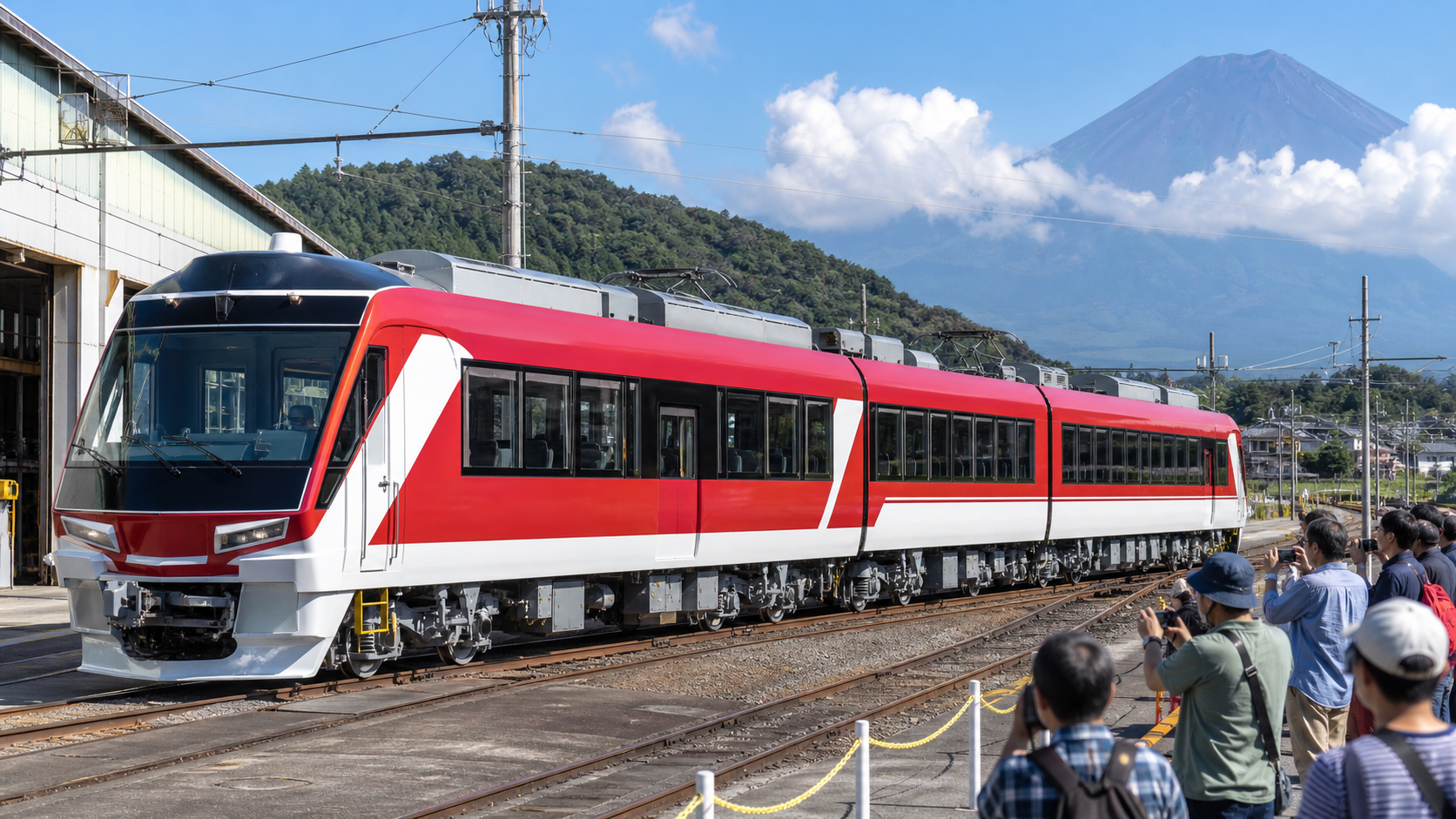 Text-free red-and-white local train presented to photographers at a Fuji-area railway depot