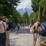 Travelers browsing a summer craft and produce market on a shrine approach near Mount Fuji