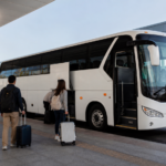 Text-free highway coach boarding travelers with luggage at a Japanese airport terminal