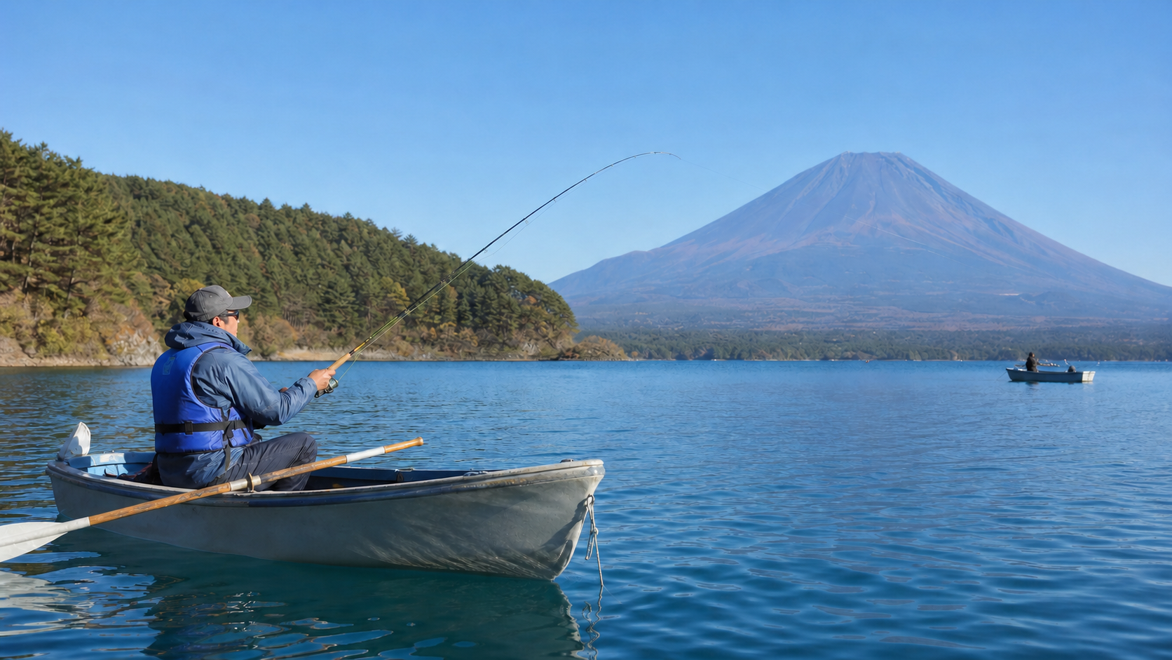 Angler in a plain life jacket fishing from a small boat on Lake Motosu with bare Mount Fuji beyond