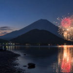 Fireworks reflected in Lake Shojiko from the pebbled Tategohama shore