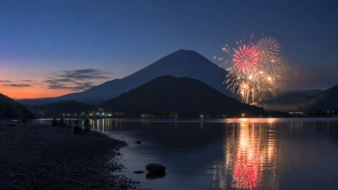 Fireworks reflected in Lake Shojiko from the pebbled Tategohama shore