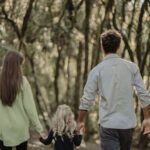 A family walking together on a shaded forest path