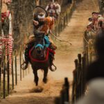 A traditional Japanese yabusame rider performing horseback archery in front of festival spectators