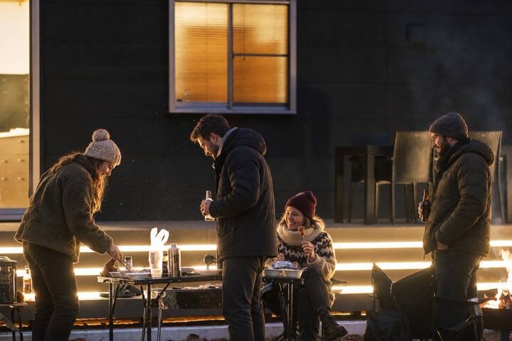 Friends enjoying an outdoor BBQ beside KINFOLK YAMANAKAKO at night