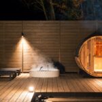 Illuminated barrel sauna and steaming round Jacuzzi on the deck at KINFOLK YAMANAKAKO