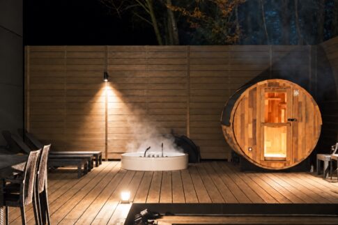 Illuminated barrel sauna and steaming round Jacuzzi on the deck at KINFOLK YAMANAKAKO