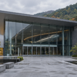 A quiet modern science museum entrance with an abstract high-speed transport exhibit inside