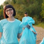 Volunteers collecting rubbish beside a river