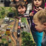 Children examining a detailed model railway display